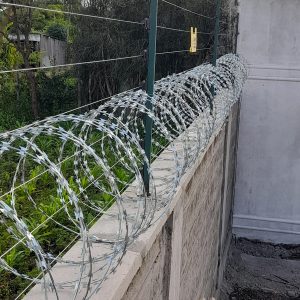 Electric fence with razor wire on wall installation in Kenya